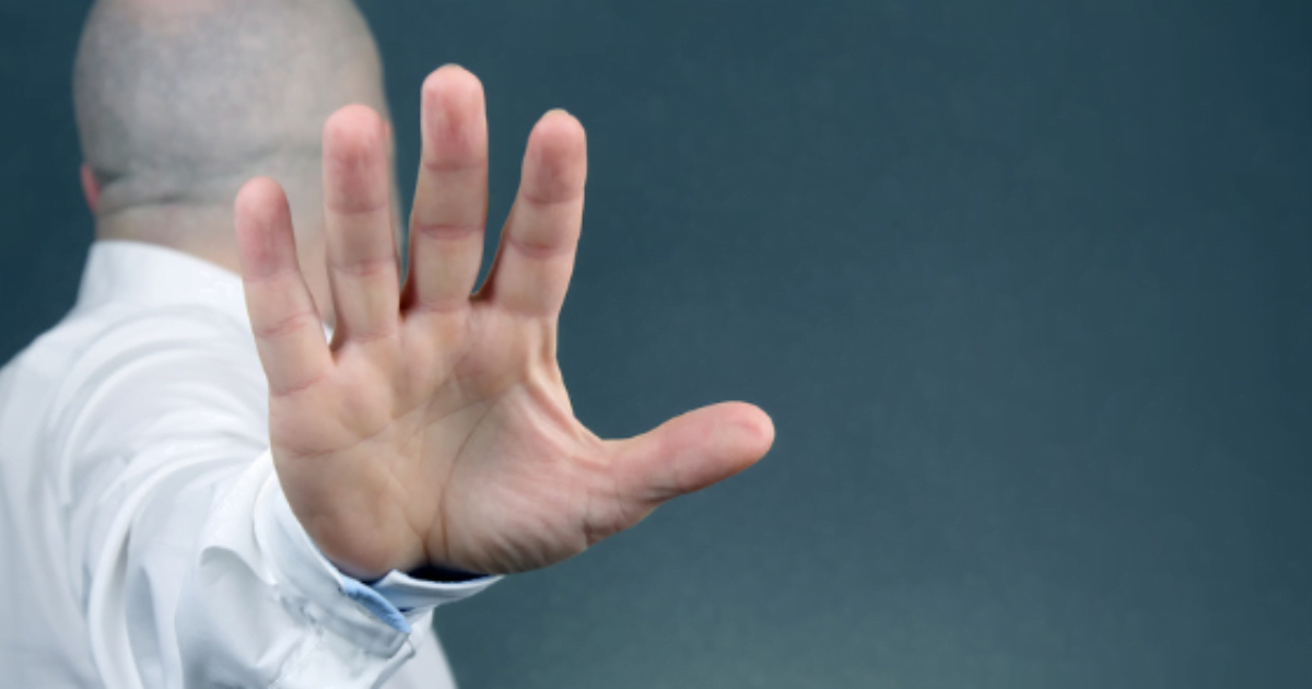 Image of a man in a white shirt with outstretched hand, depicting negative self talk.