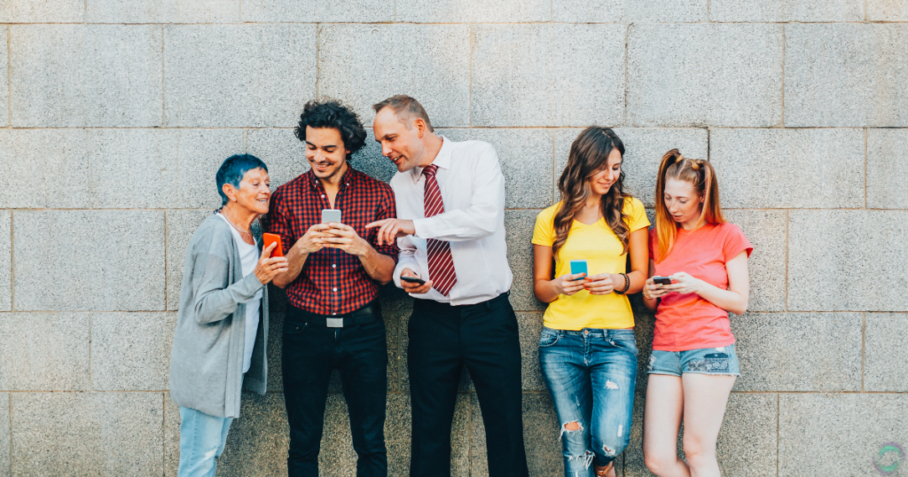 a group of different  Personality Types people looking at their phones